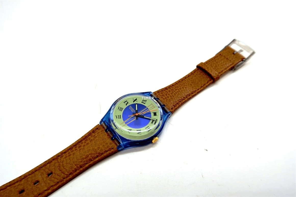 Swatch,Other 34mm,34mm,Plastic,Blue,Cream,Quartz,Sapphire,Crystal Glass,Tonneau,GN130
